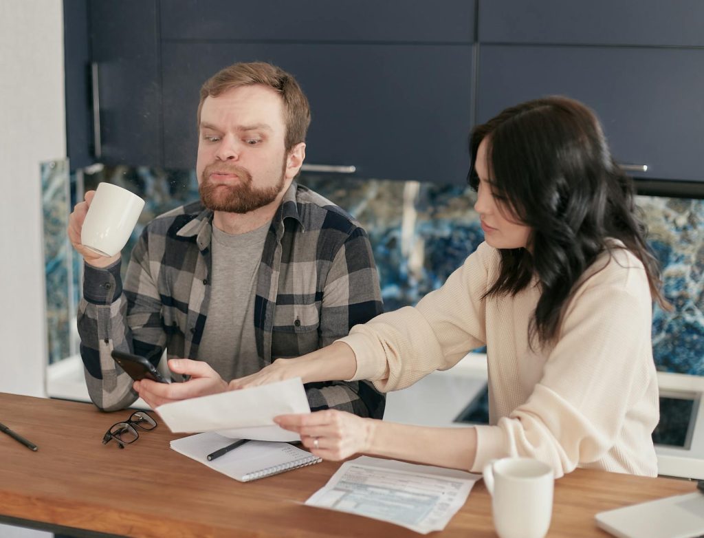 Majoration des allocations familiales à — famille discutant finances à la maison